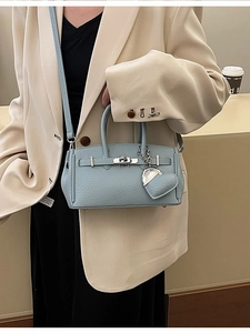 Elegante borsa azzurra in pelle martellata con chiusura argento e ciondolo a cuore