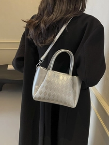 Sleek metallic silver bucket bag with woven quilted texture and round handles