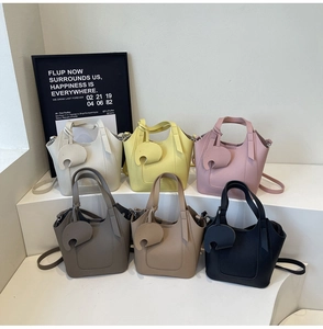 Detail of colorful mini bucket bags in lychee leather with cute elephant charms