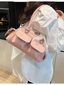 Pink patent leather Boston bag with lace bow details and double front flap pockets