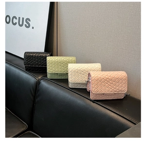 Detail of four mini woven flap bags in multiple colors with metallic chain straps