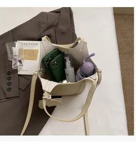 Interior view of spacious cream bucket bag with phone and umbrella storage capacity