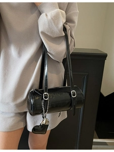 Glossy black wax leather cylinder bag with silver heart charm and double straps