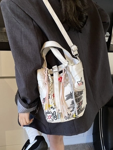 Graffiti canvas bucket bag with colorful letters and heart motifs for women