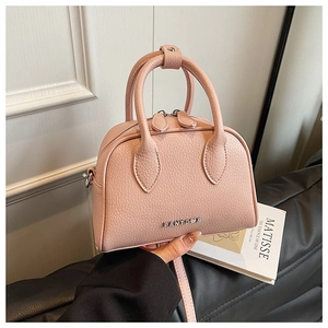 Detail of pink lychee textured leather mini Boston bag with metal PANTOR logo and top handles