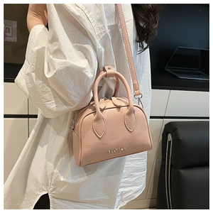 Detailed side view of pink litchi grain Boston bag with PANTUOR logo and strap