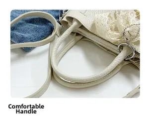 Dettaglio della borsa a secchiello in pelle bianca con pizzo, perle e cerniera argento