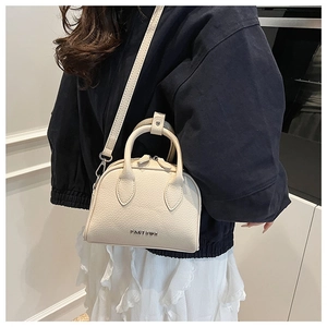 Detail of lychee textured cream Boston bag with metal PANTGOR logo and cross-body strap