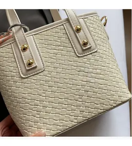 Detail of woven PU leather bucket bag with gold studs and Fashion Dilya branding