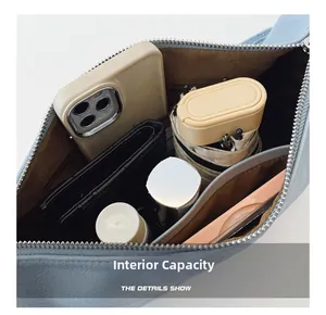Detail view of light blue leather bag interior showing large capacity and inner pockets