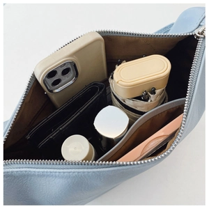 Top view of light blue dumpling bag showing large interior capacity with essentials