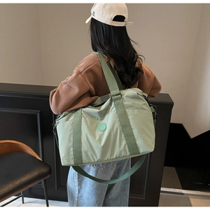 Close-up of lightweight mint green travel tote showing durable fabric and shoulder strap
