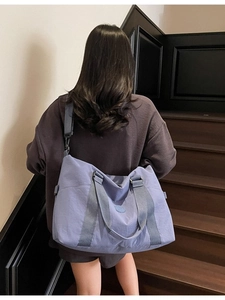 Lavender large capacity travel tote bag shown on model for sports and gym use