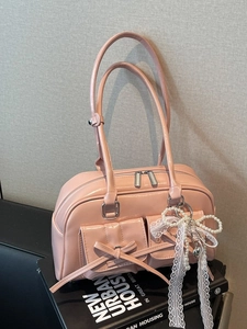 Pink glossy bowling shoulder bag with bow pockets and pearl heart charm accessory