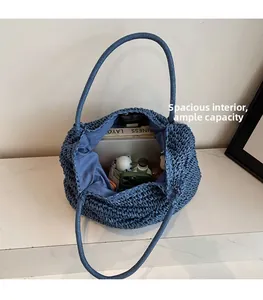 Spacious interior of blue woven tote bag showing daily essentials and large capacity