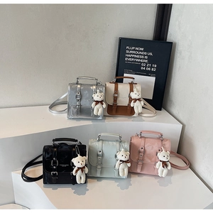 Close-up of mini PU leather backpacks in five colors featuring glossy finish and teddy charms