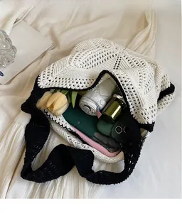 Detail view showing large capacity of hollow knit tote bag with personal items