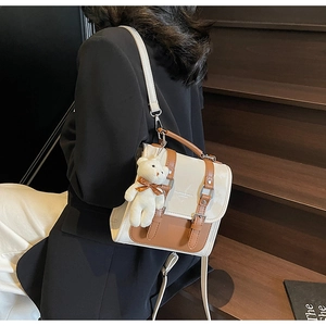 Detail of retro contrast stitching bag with buckle decor and plush bear charm
