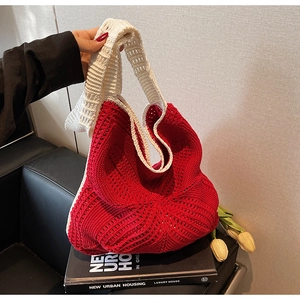 Detail of red and white hollow crochet tote bag with artisanal knit texture