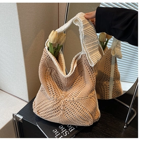Detail of hollow woven texture and cotton straps on khaki and white beach tote bag