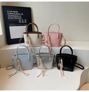 Group view of leather bucket bags in five colors with unique tennis racket pendants