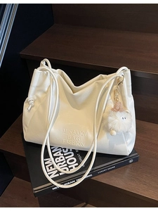 Minimalist cream white PU leather tote bag with embossed letters and plush charm