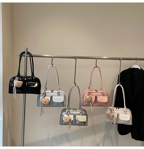 Detailansicht von Boston-Taschen in fünf Farben mit süßen braunen Plüschbären-Anhängern