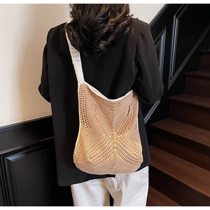 Detail of the geometric star knit pattern on the beige and cream crochet tote bag