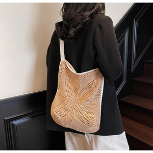 Detail of hand-crocheted tote bag featuring a star cutout pattern for summer beach use