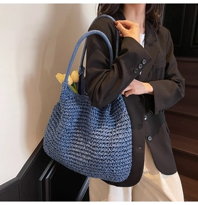 Detail showing the intricate blue woven texture and sturdy shoulder strap of this beach bag