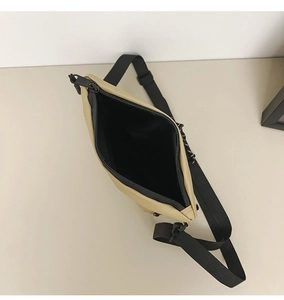 Detailed top view of beige nylon crossbody bag showing black interior lining and zipper