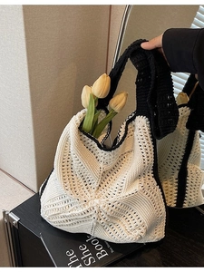 Chic black and white hand-woven crochet shoulder bag with fresh yellow tulips
