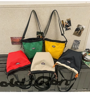 Detailed close-up of nylon checkered drawstring bags in five different colors