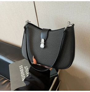 Detail of hobo bag in black textured fabric and synthetic leather with silver hardware