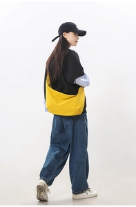 Side view of vibrant yellow crescent crossbody bag showing large storage capacity