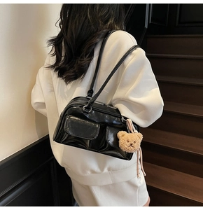 Schultertasche aus schwarzem Lackleder mit zwei Taschen und einem Plüschbär-Anhänger