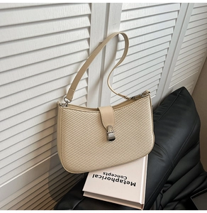 Detailed macro view of woven fabric texture and vintage silver metal buckle on a beige bag