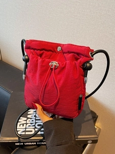 Waterproof red nylon crossbody bucket bag with adjustable drawstring for women