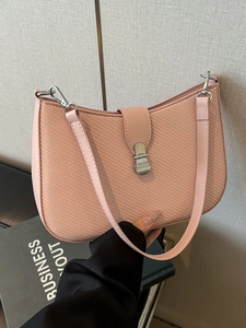 Pink woven hobo bag with silver metallic hardware and adjustable shoulder strap for women