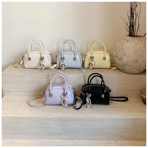 Group display of mini Boston bags in five pastel colors with pearl and bear charms