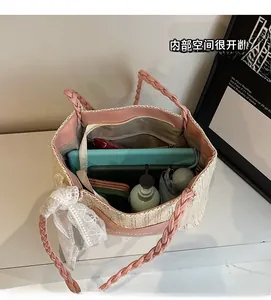 Interior view of large capacity straw tote showing tablet and accessories storage