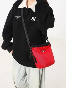 Outdoor crossbody bucket bag with red checkered pattern and adjustable black shoulder strap