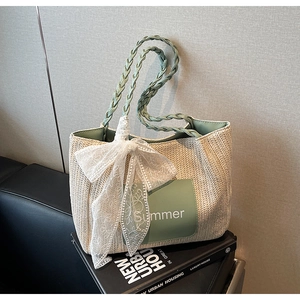 Detail of hand-woven tote bag with lace floral bow and mint green Summer patch