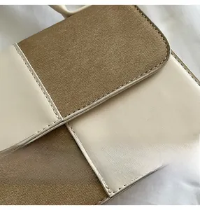 Close-up of contrast stitching on faux leather and fabric patchwork crossbody bag