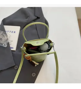 Top view of green bucket bag interior showing capacity for a folding umbrella
