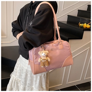 Detail of light pink nylon tote bag with bear charm and CHLO SMU metallic lettering logo