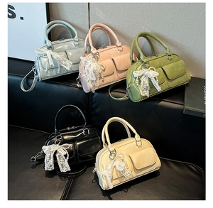 Close-up of bowling bags in multiple colors featuring lace bows and pearl charms