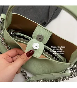 Detail of mint green pebble leather bag showing interior lining and magnetic closure