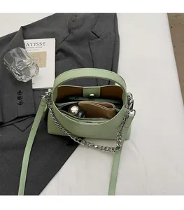 Interior view showing spacious capacity of mint green pebbled leather crossbody bag