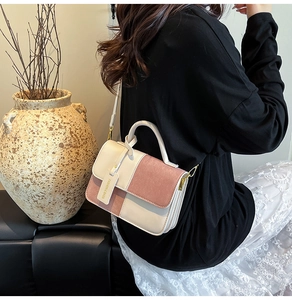Fashionable square crossbody bag with contrast stitching and elegant round handle